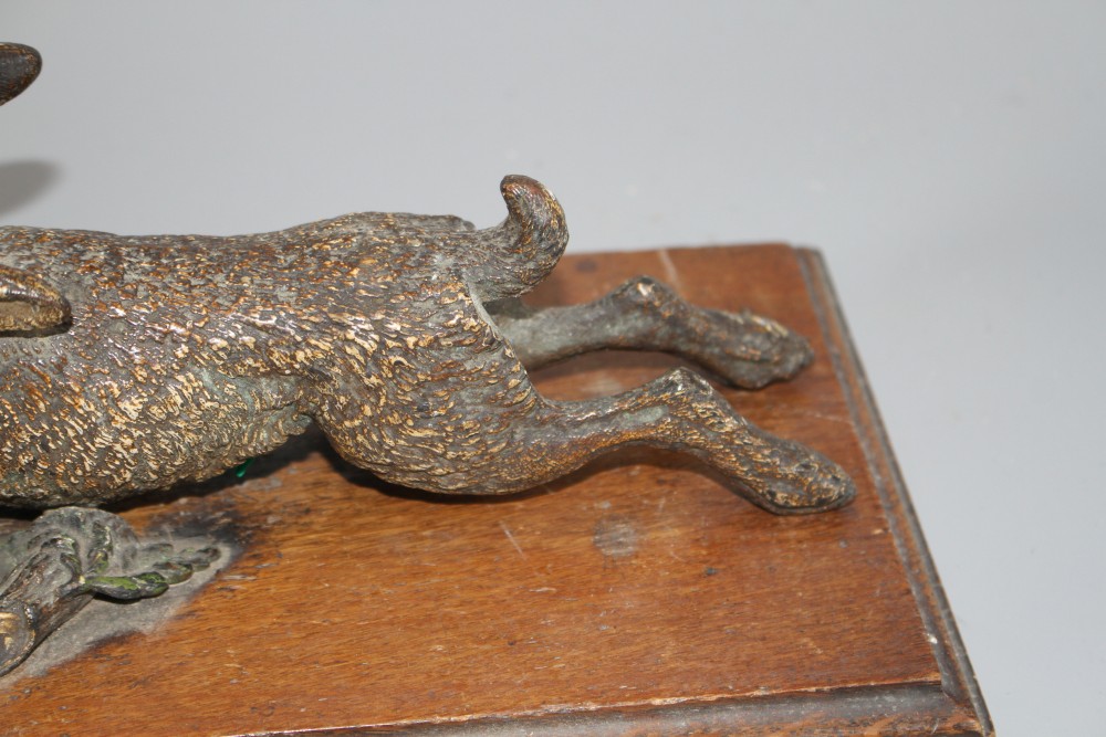An Austrian cold painted door knocker modelled as a running hare, with oak mount, overall length 30cm, width 14cm, length of hare 25cm